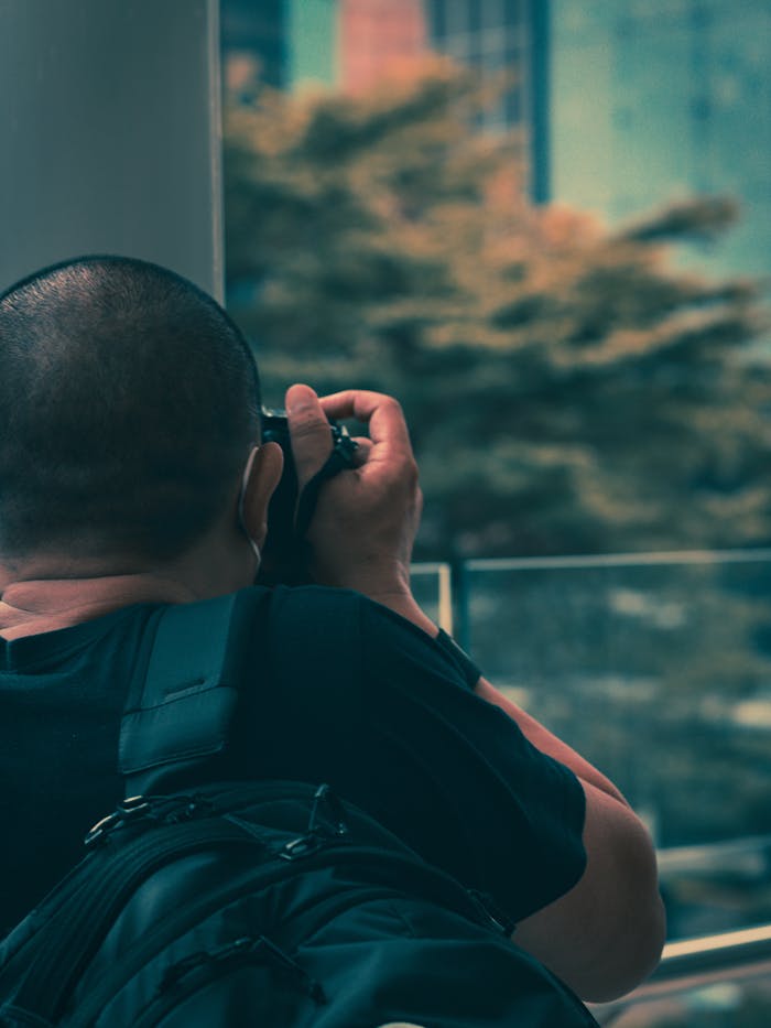 Close-up shot of a photographer in Central Jakarta, Indonesia, capturing the cityscape.